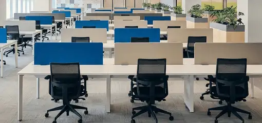 Modern open-plan office space featuring clean workstations, ergonomic chairs, and sanitized carpets provided by professional office cleaning services in Fresno, CA.