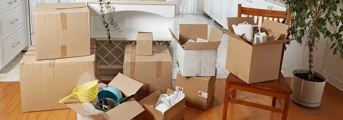 Packed moving boxes and household items in a kitchen before move-out or move-in cleaning, Fresno, CA.